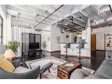 Bright living room showcasing an open floor plan, with modern decor and a comfortable seating area at 878 Peachtree Ne St # 634, Atlanta, GA 30309