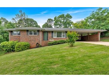Charming brick home with a well-manicured lawn and covered carport at 14 Connie St, Cartersville, GA 30121