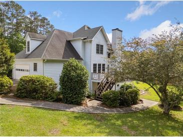 Charming home featuring a well-manicured lawn and a multi-level deck, perfect for outdoor enjoyment at 180 Butterfield Ln, Fayetteville, GA 30214