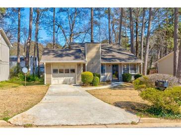 Charming single-story home featuring a one-car garage and a well-maintained front yard landscape at 2211 Jonathan Ave, Lithonia, GA 30058