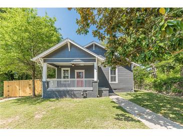 Charming bungalow featuring a covered front porch, fresh lawn and walkway at 1967 West John Calvin Ave, Atlanta, GA 30337