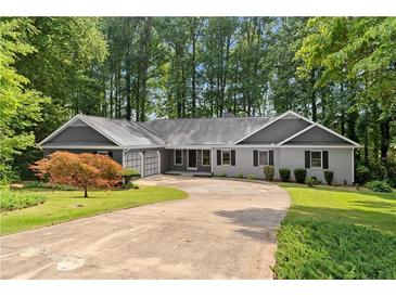 Charming ranch-style home with a well-maintained lawn and a circular driveway at 2865 Bryant Ct, Cumming, GA 30040
