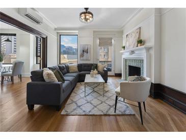 Bright living room with hardwood floors, fireplace, and comfortable seating arrangement at 75 Ponce De Leon Ave # 701, Atlanta, GA 30308