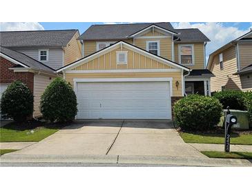 Charming two-story home with a two-car garage and well-maintained landscaping at 2428 Black Forest Dr, Conyers, GA 30012