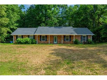 Charming one-story brick home with a well-maintained lawn and mature trees, offering a cozy and inviting curb appeal at 299 Fieldview Dr, Auburn, GA 30011