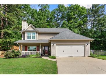 Charming two-story home with well-manicured lawn, a two-car garage, and mature landscaping at 4108 Berryhill Se Trce, Smyrna, GA 30082