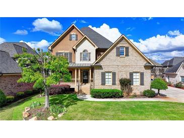 Stunning two-story home with manicured lawn, brick facade, and a welcoming front porch at 1054 Morgan Garner Sw Dr, Lilburn, GA 30047