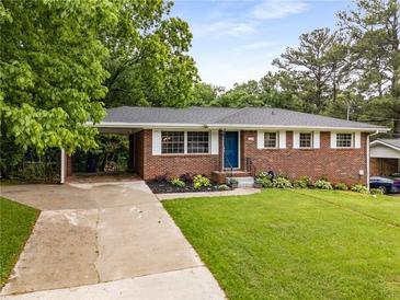 Charming brick home featuring a well-manicured lawn and tasteful landscaping at 2521 Whites Mill Ln, Decatur, GA 30032