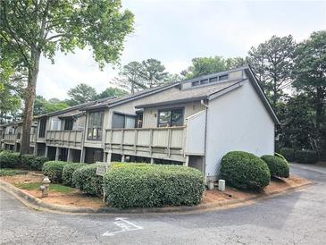 Townhome featuring multi-level decks, tidy landscaping, and painted exteriors at 5025 Highland Club Dr, Marietta, GA 30068