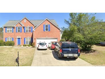 Charming two-story brick home with blue shutters and a well-manicured lawn in a suburban neighborhood at 1685 Great Oaks Dr, Lawrenceville, GA 30045
