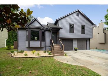 Charming gray two-story home featuring a well-manicured front yard and a two-car garage at 2872 Estuary Dr, Acworth, GA 30101