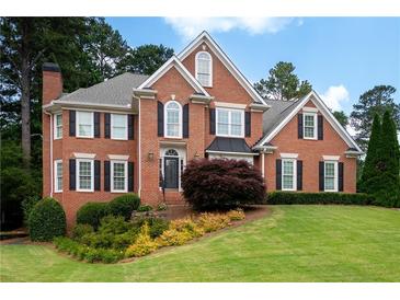Beautiful brick home with manicured lawn and mature landscaping offers classic curb appeal at 3361 Woodington Se Ct, Marietta, GA 30067