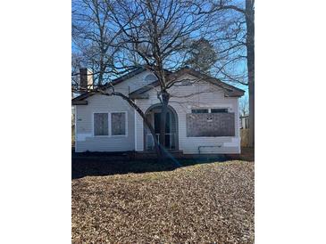 Modest single-story home showcasing its front facade on a lot covered in fallen leaves at 1406 Lakewood Se Ave, Atlanta, GA 30315