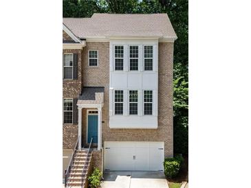 Inviting brick townhome with two-car garage and charming blue door at 1036 Grant Park Rd, Decatur, GA 30033