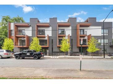 Modern townhouse with gray and white exterior, balconies, and professional landscaping at 367 Parkway Ne Dr # 4, Atlanta, GA 30312