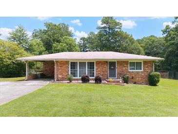 Charming brick home with a well-maintained lawn and inviting curb appeal at 4065 Old Austell Rd, Powder Springs, GA 30127