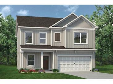 Charming two-story home with a two-car garage and a covered front porch at 383 Morgan Rd, Carrollton, GA 30116