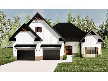 Charming new construction with a two-car garage, sleek black doors and accents, and a beautifully landscaped lawn at 4850 Wynship Ln, Snellville, GA 30039