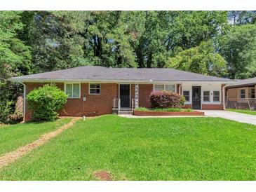 Charming brick home featuring a well-maintained lawn and mature trees at 3170 Bellgreen Way, Decatur, GA 30032