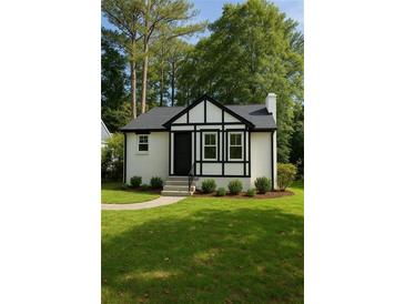 Charming home with manicured lawn, black trim, and inviting front entrance at 1658 Altadena Sw Pl, Atlanta, GA 30311