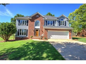 Charming two-story home with a well-manicured lawn, two-car garage and inviting brick accents at 11 Trotters Ne Walk, Cartersville, GA 30121