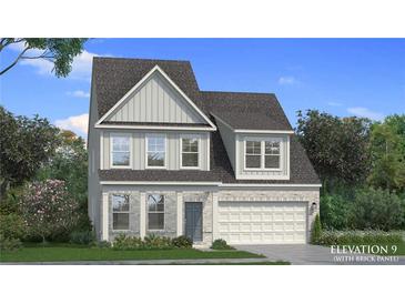 Charming two-story home showcasing stone and siding exterior, complemented by a well-manicured lawn at 2545 Dixon Pl, Lawrenceville, GA 30045