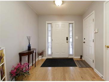 Inviting entryway features a classic white door, sidelights, and hardwood floors at 175 Prince Ct, Hiram, GA 30141