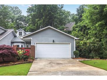 Attached two-car garage with driveway and partial view of the home's exterior at 2983 Crosswycke Forest Dr, Brookhaven, GA 30319