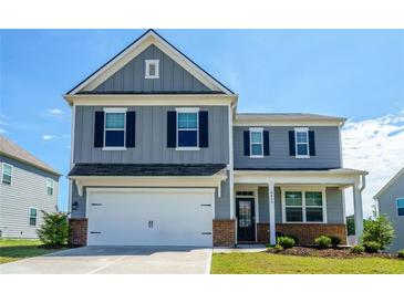 Charming two-story home featuring a two-car garage and classic curb appeal at 4420 Merrigold Way, Fairburn, GA 30213