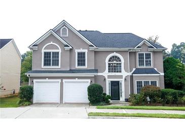 Charming two-story home with a two-car garage and manicured landscaping at 4000 Longlake Dr, Duluth, GA 30097