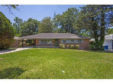 Charming brick ranch-style home featuring a well-maintained lawn and complemented by lush, mature trees at 2261 Star Mist Sw Dr, Atlanta, GA 30311