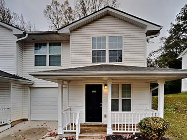 Charming two-story home features a covered front porch and well-maintained landscaping at 1232 Pinedale Nw Cir, Conyers, GA 30012