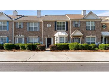 Charming brick townhouse with manicured shrubs and a well-maintained facade at 2727 Parkway Trl, Lithonia, GA 30058