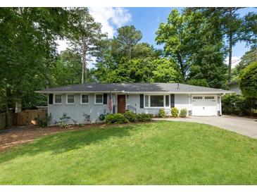 Charming single story home with a well manicured front yard, driveway and garage at 2164 Medfield Trl, Atlanta, GA 30345