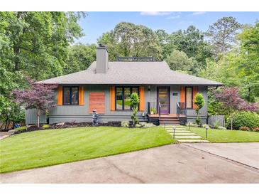 Charming home featuring a well-manicured lawn, modern facade, and beautiful landscaping at 921 Oak Dr, Woodstock, GA 30189