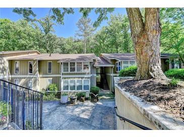 Inviting exterior view of a multi-story townhome surrounded by mature trees at 5149 Roswell Rd # 7, Atlanta, GA 30342