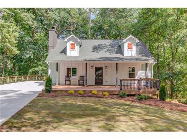 Charming cottage-style home with a welcoming front porch and well-manicured lawn at 5345 Pilgrim Point Rd, Cumming, GA 30041