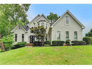 Charming two-story home featuring manicured lawn, and a beautiful facade at 1595 Chadberry Way, Lawrenceville, GA 30043