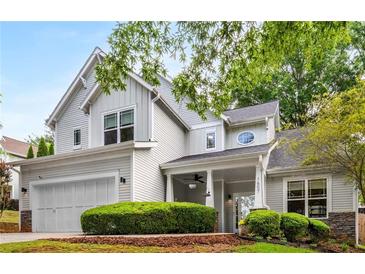 Charming two-story home featuring a well-manicured lawn, covered porch, and attached two-car garage at 1607 Boulder Walk Se Dr, Atlanta, GA 30316