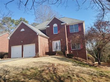 Charming two-story brick home with a manicured lawn and a two-car garage at 4217 Mill Grove Sw Ln, Smyrna, GA 30082