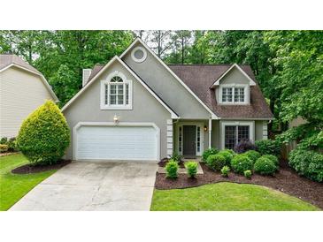 Charming single-Gathering home with a well-manicured lawn and an attached two-car garage at 8895 Club River Dr, Roswell, GA 30076