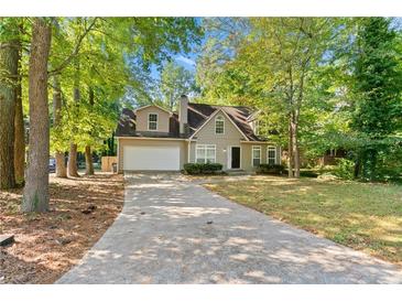 Charming two-story home with a well-manicured lawn and a spacious driveway leading to a two-car garage at 1333 Laura Ln, Austell, GA 30168