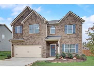 Charming two-story brick home features a two-car garage, manicured lawn, and inviting curb appeal at 1173 Gaines St, Jonesboro, GA 30238