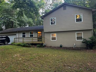 Charming two-story home with neutral siding, a front porch, and well-maintained landscaping at 3474 Leaf Land Ct, Duluth, GA 30097
