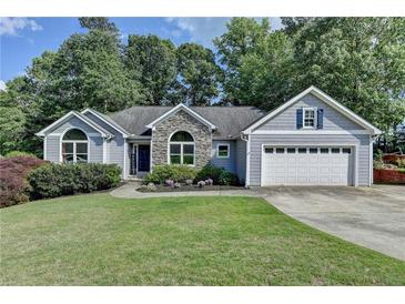 Charming home with lush lawn, stone accents, and two car garage at 1882 Flowering Dr, Grayson, GA 30017