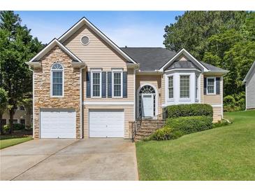Charming home with stone accents, two-car garage, landscaped yard, and inviting front entrance at 33 Evans Pt, Dallas, GA 30157