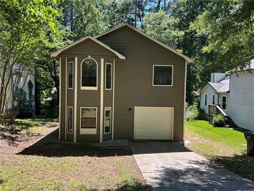 Charming two-story home with unique architectural details and an attached one car garage at 4433 Ford Pl, Snellville, GA 30039