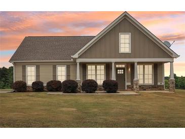 Charming single-story home with a welcoming front porch and well-manicured lawn at 625 Henderson Mill Rd, Covington, GA 30014