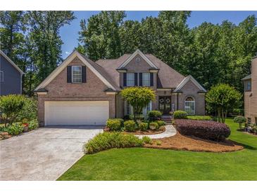Charming brick home boasts a well-manicured lawn and inviting curb appeal at 1668 Macy Ln, Lawrenceville, GA 30043