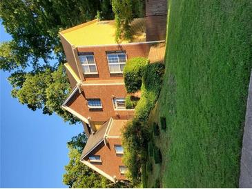 Beautiful two-story brick home with manicured lawn, mature trees, and symmetrical window placement at 3119 Grant Way, East Point, GA 30344